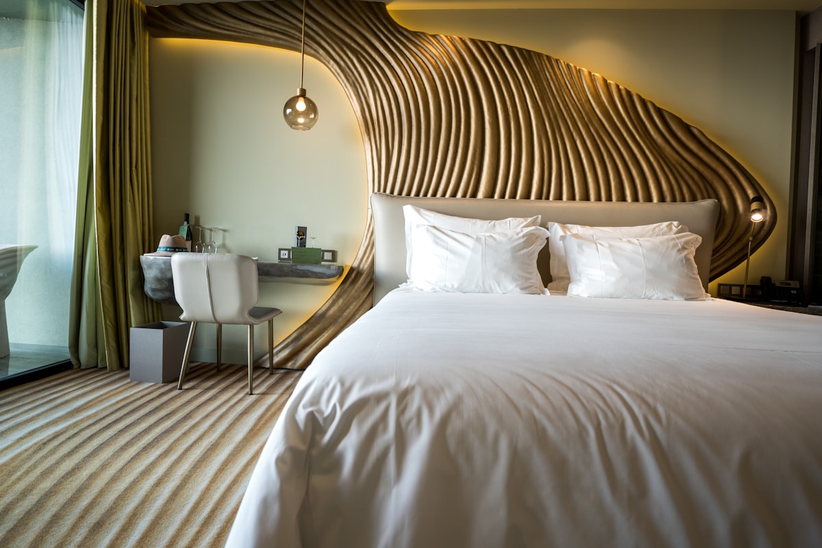 Immaculately made hotel bed with crisp white linens